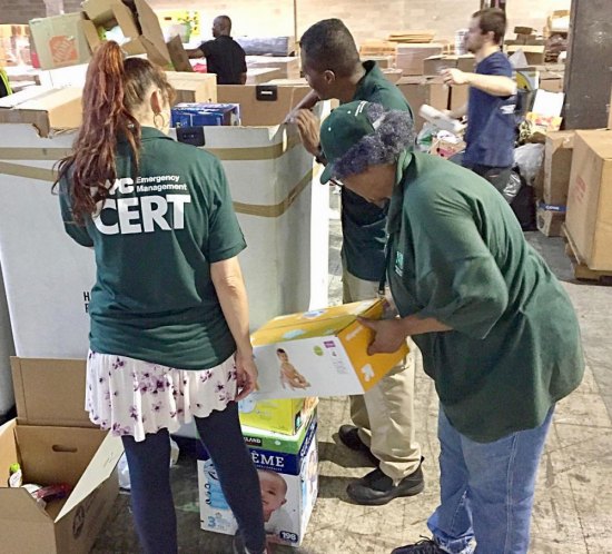 Roosevelt Islanders, All Ages, Pitch In for Puerto Rico Gwen Ryals assists in packing up donations.
